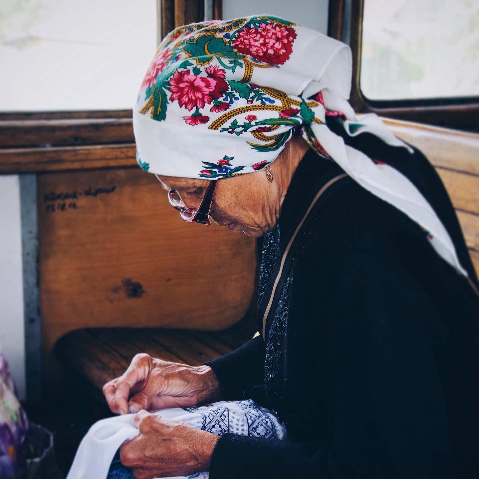 Woman sewing traditional fabric