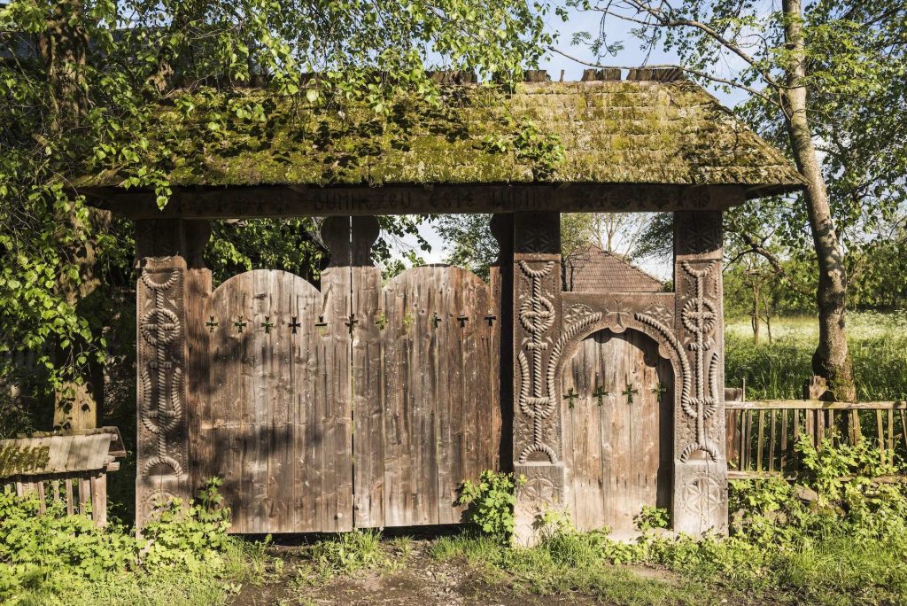 a carved wooden gate near Breb village