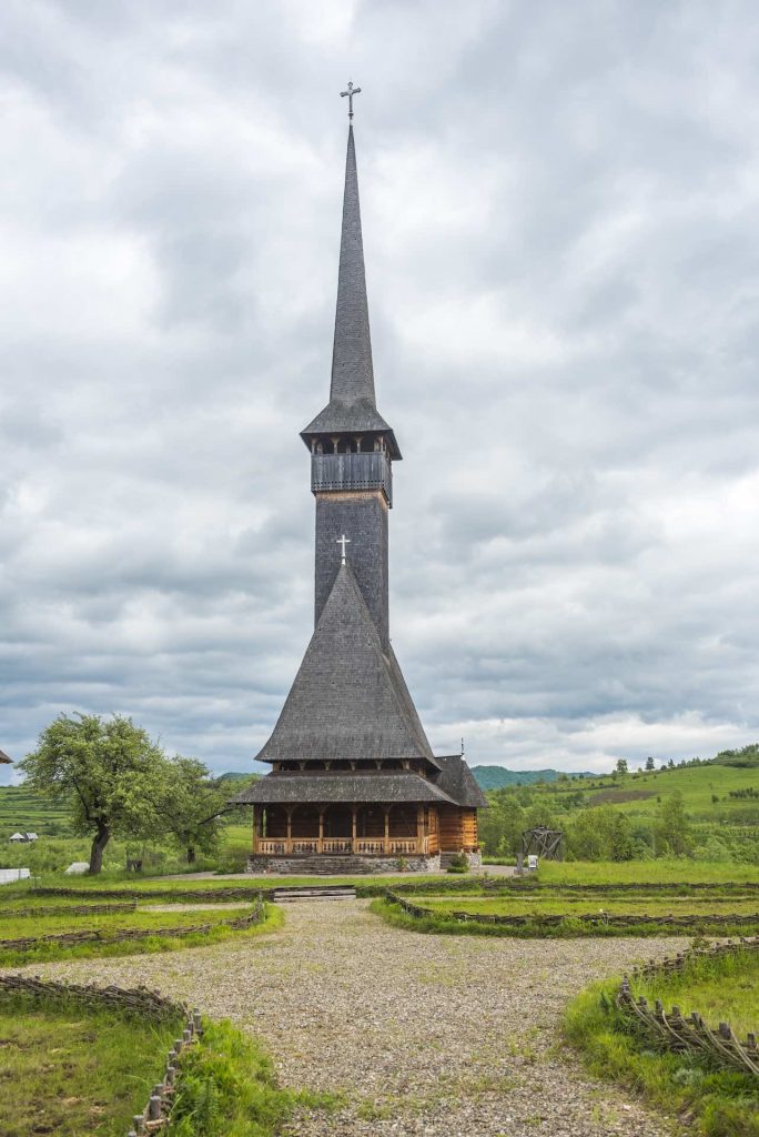 One of the Wooden Churches, with a tall and slim bell tower
